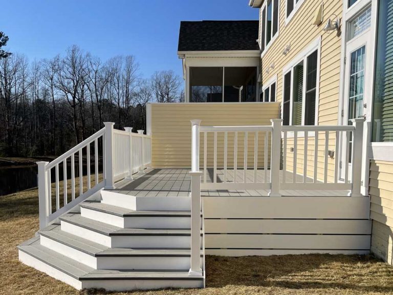 Deck with flair steps and white vinyl rail