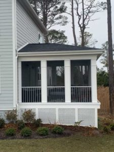 Screened porch with white trim and lattice