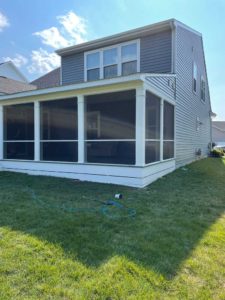 Screened porch with white trim on gray home