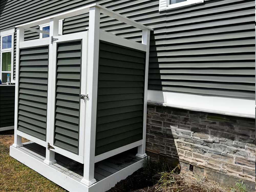 outside shower stall with gray vinyl siding to match gray vinyl siding on home